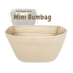 May include: Beige felt bag organizer for a Mini Bumbag. The organizer is designed to fit inside the bag, with a structured shape and stitched seams. The text "DESIGNED FOR Mini Bumbag" is visible in the image.