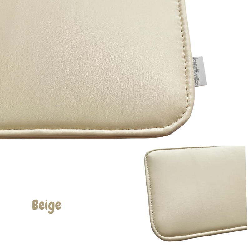 May include: Beige-colored rectangular cushion with rounded corners. The cushion has a stitched border and a smooth surface. A small tag is attached to the side. The word "Beige" is written in a cursive font.