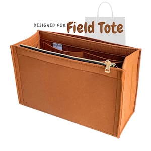May include: A brown felt tote bag organizer with a black zipper and gold-colored zipper pull. The organizer has multiple interior pockets and is designed for a Field Tote.