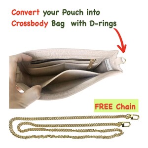 May include: Beige pouch with a zip and internal pockets, designed to convert into a crossbody bag. Includes a gold-coloured chain strap with clasps. Text on the image reads: "Convert your Pouch into Crossbody Bag with D-rings" and "FREE Chain".