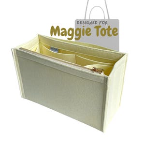 May include: Cream-coloured tote bag organiser with a zipped top and multiple interior compartments. The organiser is designed for a "Maggie Tote" and features a gold-coloured zip and a light yellow interior.