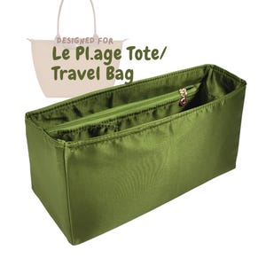 May include: Olive green tote bag organizer with a zippered closure and multiple compartments. The text "DESIGNED FOR Le Plage Tote/ Travel Bag" is visible in the image. The organizer is designed to fit inside a tote bag.