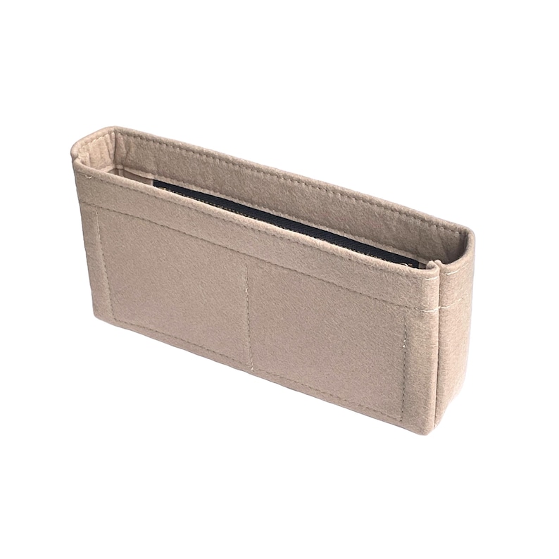 May include: Beige felt bag organizer with multiple compartments and a zippered top.