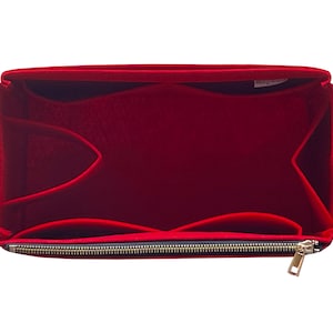 May include: Red felt bag organiser with multiple compartments and a zipper closure.