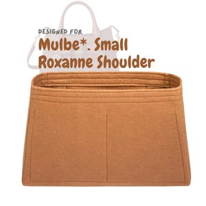 May include: A tan felt bag organiser with the text "DESIGNED FOR Mulbe*. Small Roxanne Shoulder". The organiser has a rectangular shape with multiple compartments and is designed to fit inside a handbag.