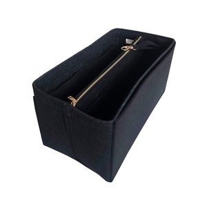 May include: Black felt bag organizer with multiple compartments and a zipper closure. The organizer is designed to fit inside a larger bag.