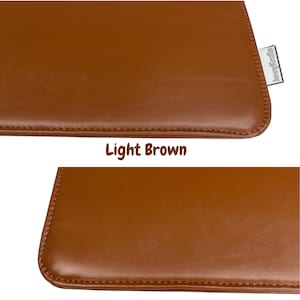 May include: Close-up of a light brown leather product with a stitched edge. The product has a smooth surface and a small tag in the corner with the text "jennykrafts". The text "Light Brown" is below the product.
