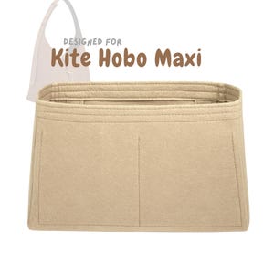 May include: Beige felt bag organizer designed for the Kite Hobo Maxi bag. The organizer has multiple compartments and is rectangular in shape. The text "DESIGNED FOR Kite Hobo Maxi" is printed above the organizer.