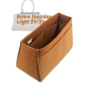 May include: A tan felt bag organizer with multiple compartments, designed for a Birkin Shoulder Light 29/39 bag. The organizer has several pockets and is made of a soft, durable material.