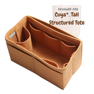 May include: A tan felt tote bag organizer with multiple compartments and pockets. The organizer is designed for a tall, structured tote bag. The text "Designed for Cuya*. Tall Structured Tote" is visible.