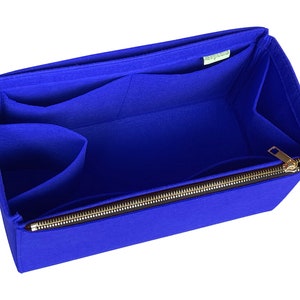 May include: Blue felt bag organiser with multiple pockets and a zipper closure. The organiser is designed to fit inside a larger bag.