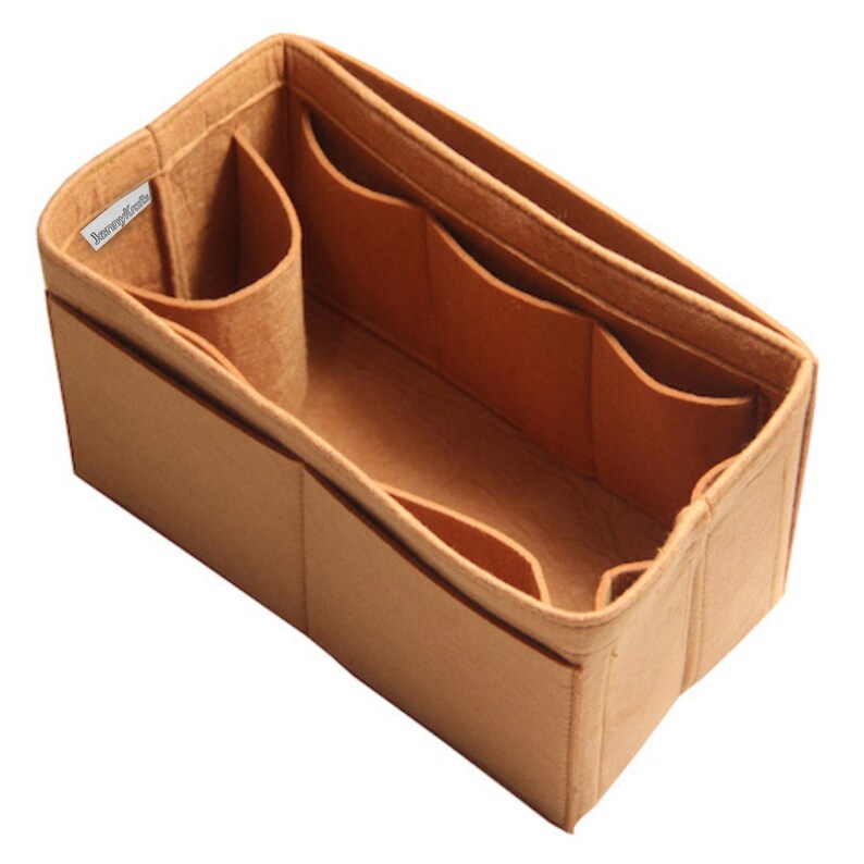 May include: A rectangular tan felt bag organizer with multiple interior and exterior compartments. The structure features a small white fabric label with the text JennyKrafts sewn into the upper left corner, providing organized storage space.
