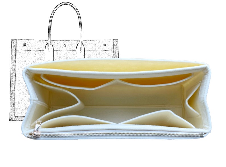 May include: White felt bag organiser with multiple compartments and a zipped pocket. The organiser is designed to fit inside a larger tote bag.