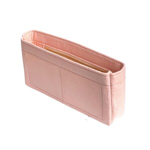 May include: A light pink felt bag organizer with a zippered compartment and two open pockets.