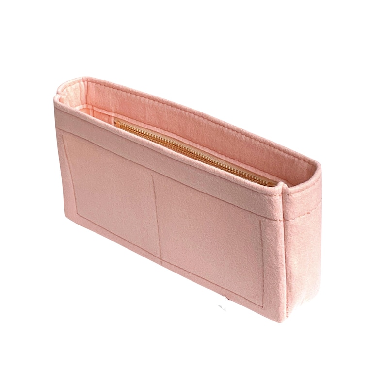 May include: A light pink felt bag organizer with a zippered compartment and two open pockets.