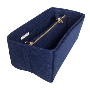 May include: A navy blue felt bag organizer with multiple compartments and a zippered pocket. The organizer has a gold zipper and a label that reads "JennyKrafts".