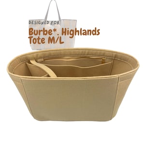 May include: Beige tote bag organizer with multiple compartments and a zippered top. The bag has a rectangular shape and is made of a soft, felt-like material. The text "DESIGNED FOR Burbe* Highlands Tote M/L" is printed on a white tote bag in the background.