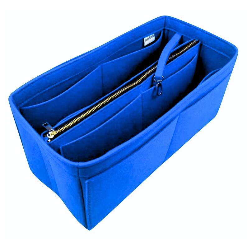 May include: A vibrant blue felt handbag organiser with several compartments and a zipped section. The organiser features a gold-coloured zip and a small handle. Designed to keep the contents of a handbag tidy and organised.