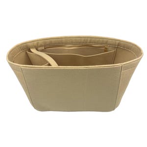 May include: Beige felt bag organizer with multiple compartments and a zippered pocket.