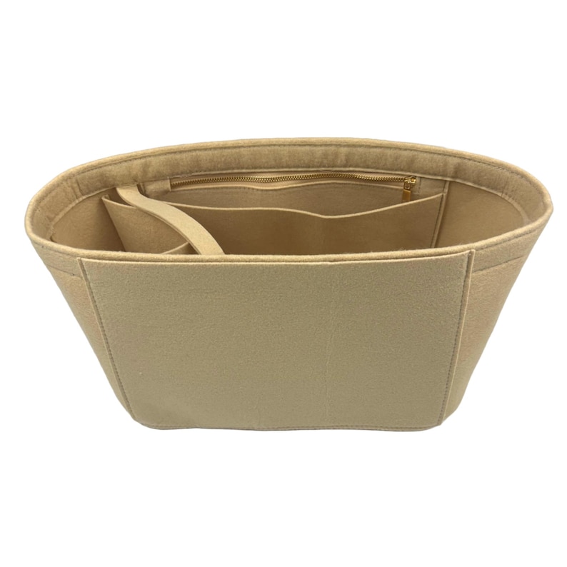 May include: Beige felt bag organizer with multiple compartments and a zippered pocket.
