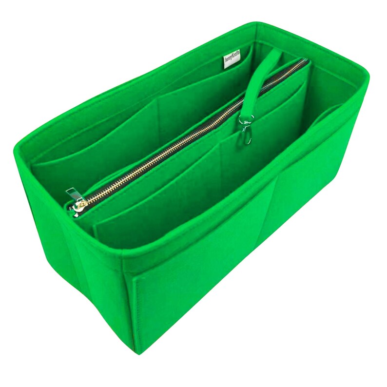 May include: Vibrant green felt handbag organiser with several compartments and a zipped section. It has a silver zip and a small handle. Designed to fit inside a larger bag, it helps keep items tidy.
