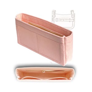 Peut inclure: Un organiseur de sac en feutre rose avec plusieurs compartiments et une fermeture à glissière. L'organisateur est conçu pour s'adapter à l'intérieur d'un sac à main.