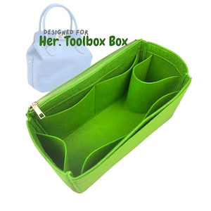 May include: A bright green felt bag organizer with multiple compartments and a gold zipper. The text "DESIGNED FOR Her. Toolbox Box" is visible. A light blue handbag is in the background.