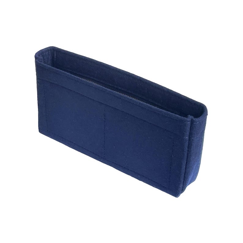 May include: A dark blue felt bag organizer with multiple compartments and a zipper closure.