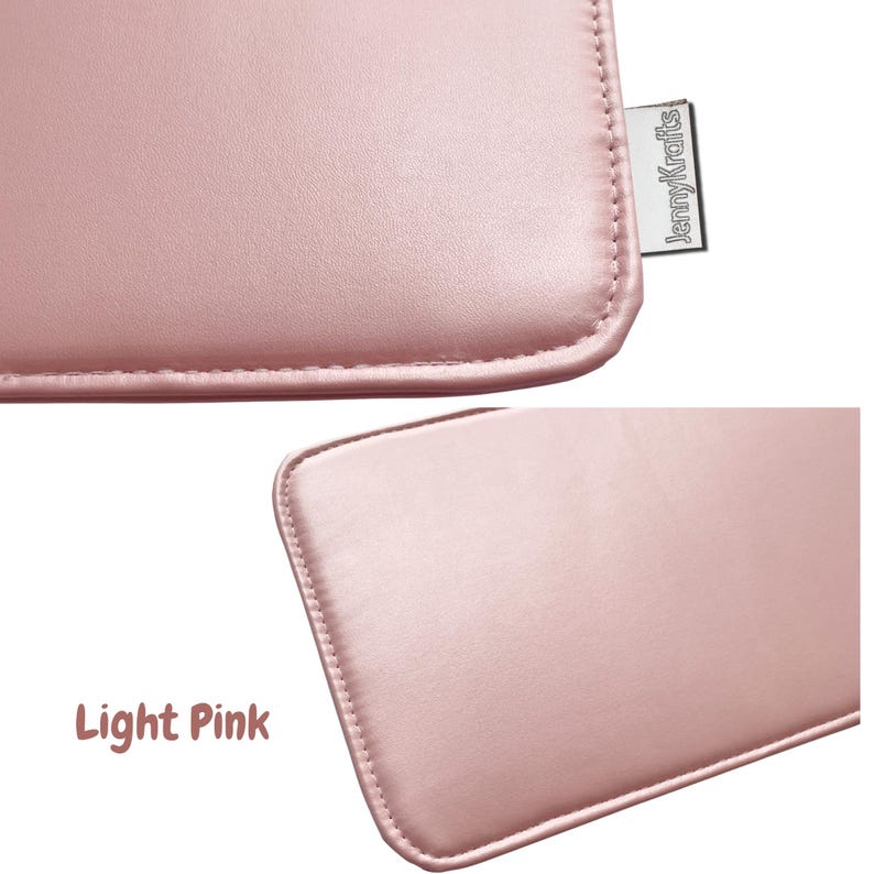 May include: Close-up of a light pink, rectangular item with rounded corners and stitched edges. The item has a smooth, leather-like texture. A small, rectangular tag with the text "JennyKrafts" is attached to the item.