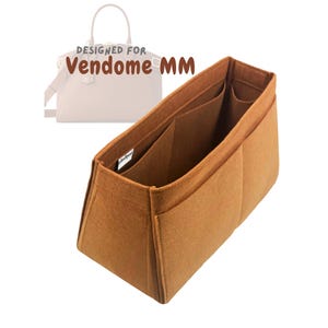 May include: A brown felt bag organizer designed for the Vendome MM handbag. The organizer has multiple compartments and pockets to help keep your bag organized.