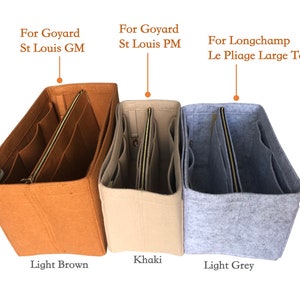 May include: Three felt bag organizers in different colors: light brown, khaki, and light grey. The organizers are labeled with the brands they are compatible with: Goyard St. Louis GM, Goyard St. Louis PM, and Longchamp Le Pliage Large Tote.