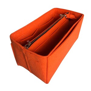 May include: Orange felt bag organizer with multiple compartments and a zippered pocket.