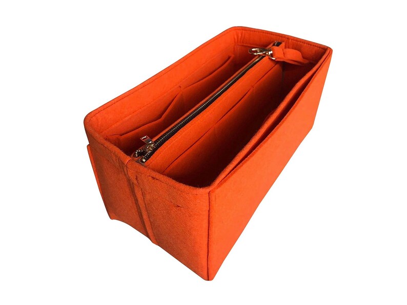 May include: Orange felt bag organizer with multiple compartments and a zippered pocket.