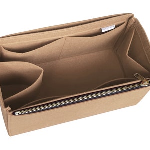 May include: Beige felt bag organiser with multiple pockets and a zipped compartment. The organiser has a label that reads "Bag Organiser".