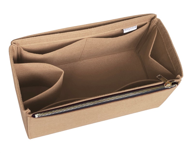 May include: Beige felt bag organiser with multiple pockets and a zipped compartment. The organiser has a label that reads "Bag Organiser".
