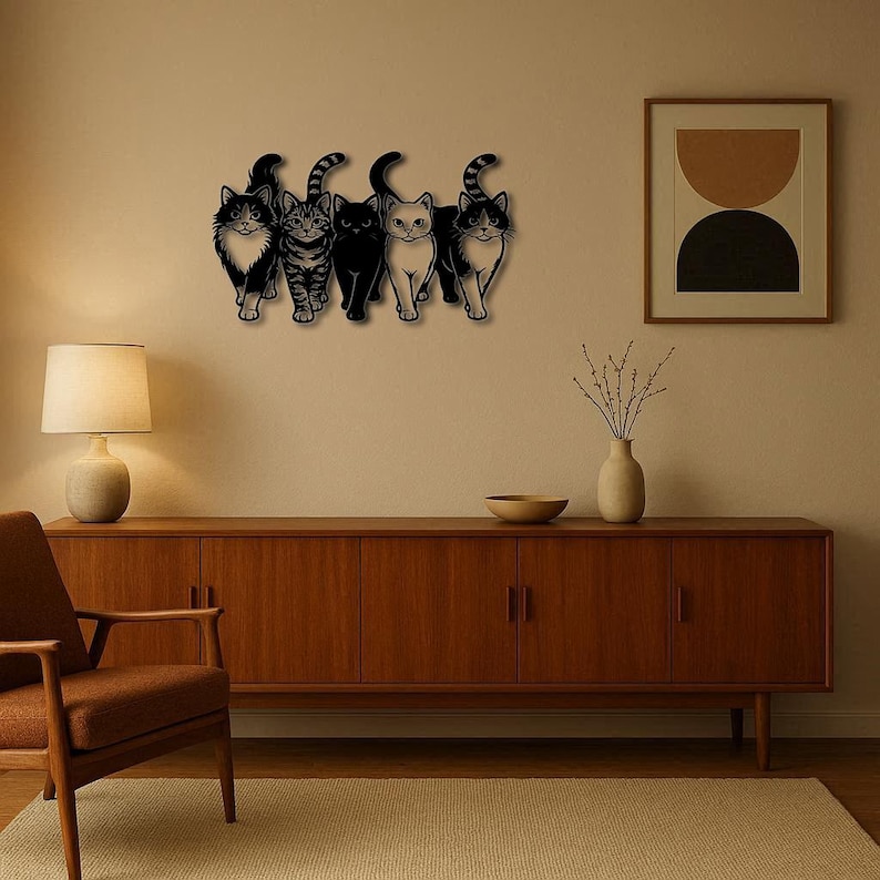 May include: A wooden wall art piece featuring five stylized cat silhouettes in black. The cats have varying patterns and poses, creating a playful and decorative element. The artwork is mounted on a neutral-colored wall.