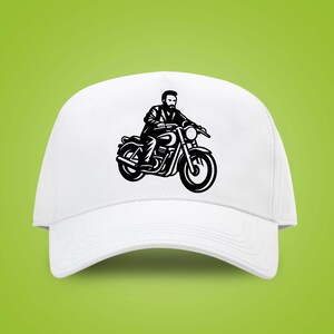 May include: White baseball cap featuring a black illustration of a person riding a motorcycle. The graphic depicts a bearded rider on a classic motorcycle. The cap has a curved brim and a structured crown, suitable for casual wear.