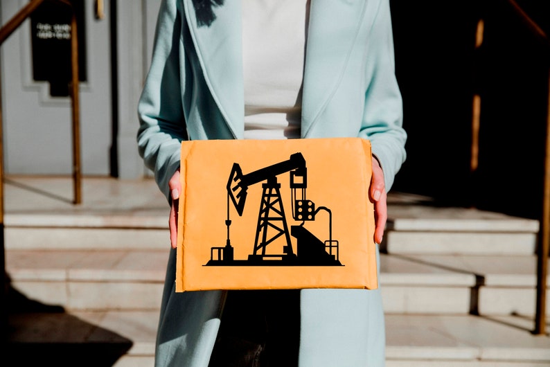 May include: A person holding a brown cardboard envelope with a black silhouette of an oil derrick on the front.