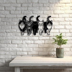 May include: A black metal wall art piece featuring five stylized cat silhouettes. Each cat has a unique pattern, including solid black, tabby stripes, and tuxedo markings. The cats are mounted on a white brick wall.