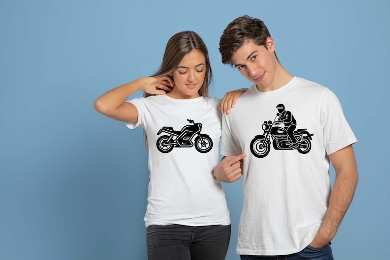 May include: White t-shirts with black motorcycle graphics. One shirt features a motorcycle, the other depicts a person riding a motorcycle. The shirts are worn by two people, set against a blue background.