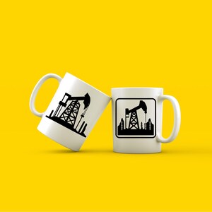May include: Two white ceramic mugs with black silhouettes of oil derricks. One mug has a simple silhouette, while the other has a silhouette inside a square.