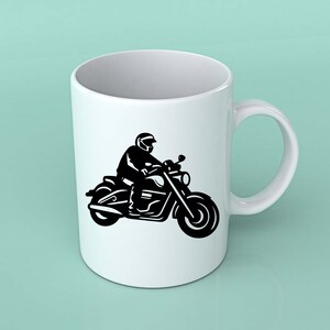 May include: White ceramic mug featuring a black silhouette of a person riding a motorcycle. The motorcycle has detailed elements, including the handlebars, lights, and wheels. The mug has a curved handle and a smooth, glossy finish.