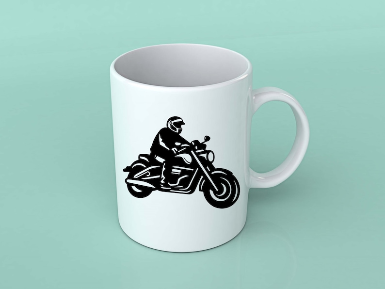 May include: White ceramic mug featuring a black silhouette of a person riding a motorcycle. The motorcycle has detailed elements, including the handlebars, lights, and wheels. The mug has a curved handle and a smooth, glossy finish.