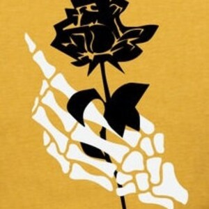 Peut inclure: Une rose noire tenue par une main squelettique blanche. La rose est au centre de l'image et la main est sur le c&ocirc;t&eacute; gauche de l'image.