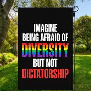 May include: A rectangular black garden flag featuring the white text "IMAGINE BEING AFRAID OF" at the top, the word "DIVERSITY" in rainbow-colored letters in the middle, and the white text "BUT NOT" followed by red text "DICTATORSHIP" at the bottom.