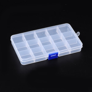 May include: A clear plastic storage box with 15 compartments and a blue latch. The box has a small handle on the top.