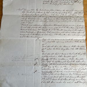 May include: A vintage off-white paper document dated February 1835, featuring handwritten cursive text in dark ink. The document is an abstract of title for property in Nether Broughton, Leicestershire, with visible fold lines and a small pink tag.
