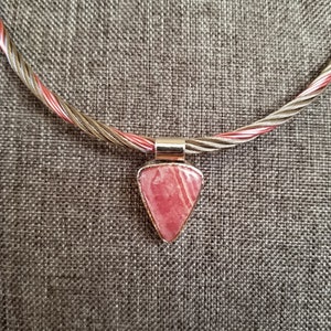 Collar style necklace. Natural Rhodochrosite stone. Sterling silver setting. Stainless steel rope & colored copper wire. Heart Chakra stone.