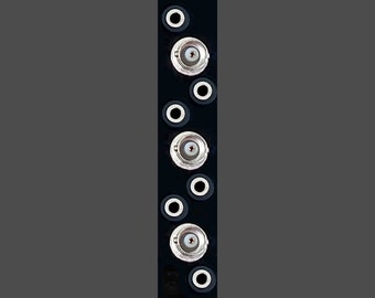 May include: A black metal panel with eight circular holes, six of which have silver metal connectors. The panel has a small hole at the top.