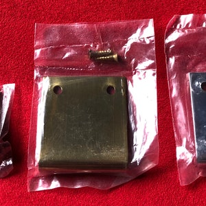 May include: Three cabinet door pulls in individual plastic bags. The pulls are made of metal and are available in silver, brass, and chrome finishes. Each pull has two screw holes.